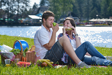 Image showing happy young couple having a picnic outdoor