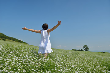 Image showing Young happy woman in green field