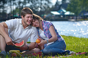 Image showing happy young couple having a picnic outdoor