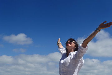 Image showing happy young woman with spreading arms to sky