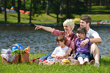 Image showing Happy family playing together in a picnic outdoors