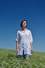 Image showing Young happy woman in green field