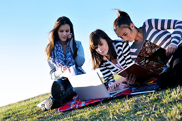 Image showing group of teens working on laptop outdoor