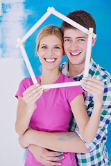 Image showing happy couple paint wall at new home