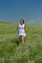 Image showing Young happy woman in green field