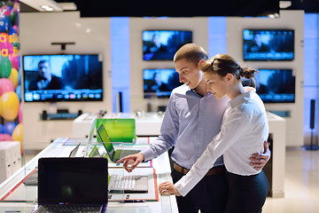 Image showing Young couple in consumer electronics store