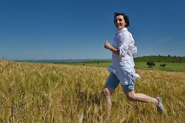 Image showing young woman in wheat field at summer