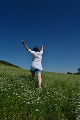 Image showing Young happy woman in green field