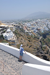 Image showing Greek woman on the streets of Oia, Santorini, Greece