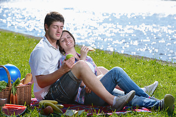 Image showing happy young couple having a picnic outdoor