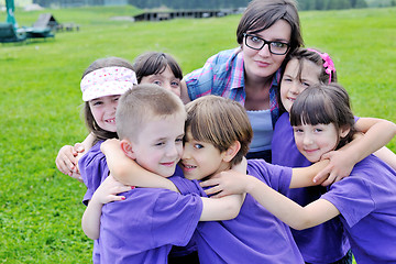 Image showing happy kids group with teacher in nature