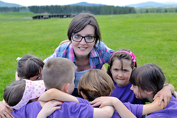 Image showing happy kids group with teacher in nature