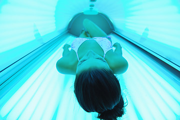 Image showing Beautiful young woman tanning in solarium