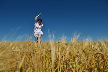 Image showing young woman in wheat field at summer