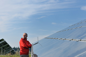 Image showing engineer using laptop at solar panels plant field