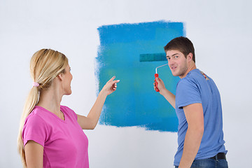 Image showing happy couple paint wall at new home