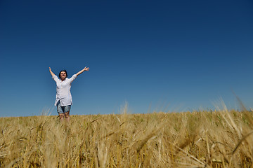 Image showing young woman in wheat field at summer