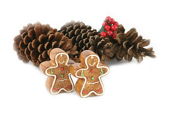 Image showing Gingerbread men and pine cones (focus on gingerbread men)