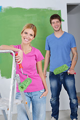 Image showing happy couple paint wall at new home