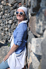 Image showing Greek woman on the streets of Oia, Santorini, Greece