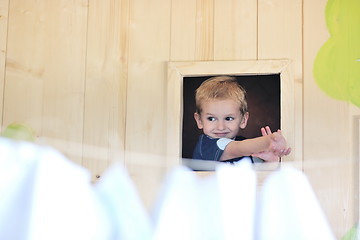 Image showing happy child in a window