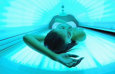 Image showing Beautiful young woman tanning in solarium