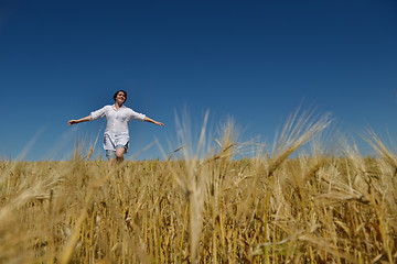 Image showing young woman in wheat field at summer