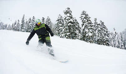 Image showing snowboarder on fresh deep snow