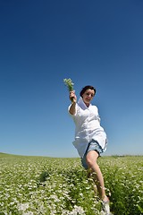 Image showing Young happy woman in green field