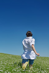 Image showing Young happy woman in green field