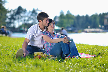 Image showing happy young couple having a picnic outdoor