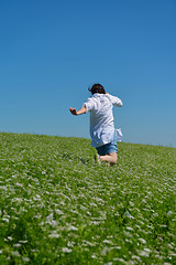 Image showing Young happy woman in green field