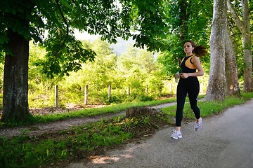 Image showing Young beautiful  woman jogging