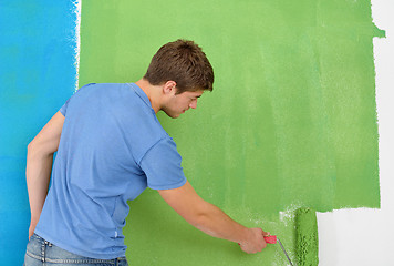 Image showing happy couple paint wall at new home