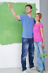 Image showing happy couple paint wall at new home