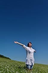 Image showing Young happy woman in green field