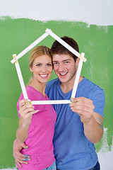 Image showing happy couple paint wall at new home