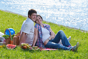 Image showing happy young couple having a picnic outdoor