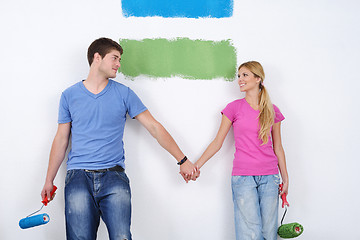 Image showing happy couple paint wall at new home