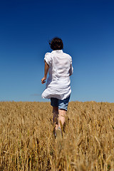 Image showing young woman in wheat field at summer