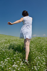 Image showing Young happy woman in green field