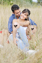 Image showing happy couple enjoying countryside picnic in long grass