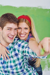 Image showing happy couple paint wall at new home