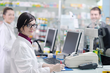 Image showing pharmacist suggesting medical drug to buyer in pharmacy drugstor