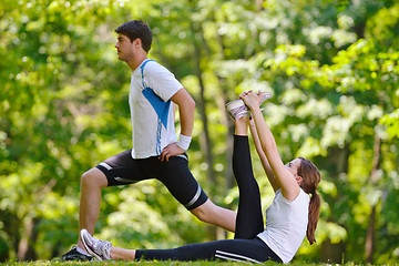 Image showing Couple doing stretching exercise  after jogging