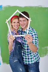 Image showing happy couple paint wall at new home