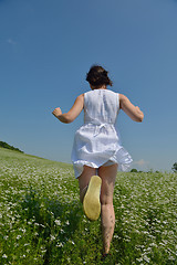 Image showing Young happy woman in green field