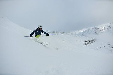 Image showing skiing on fresh snow at winter season at beautiful sunny day