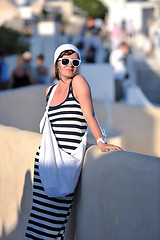 Image showing Greek woman on the streets of Oia, Santorini, Greece