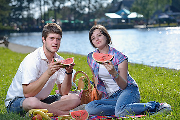 Image showing happy young couple having a picnic outdoor